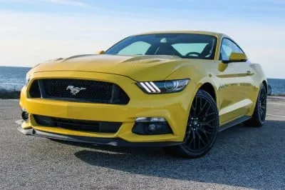 Yellow mustang parked outside